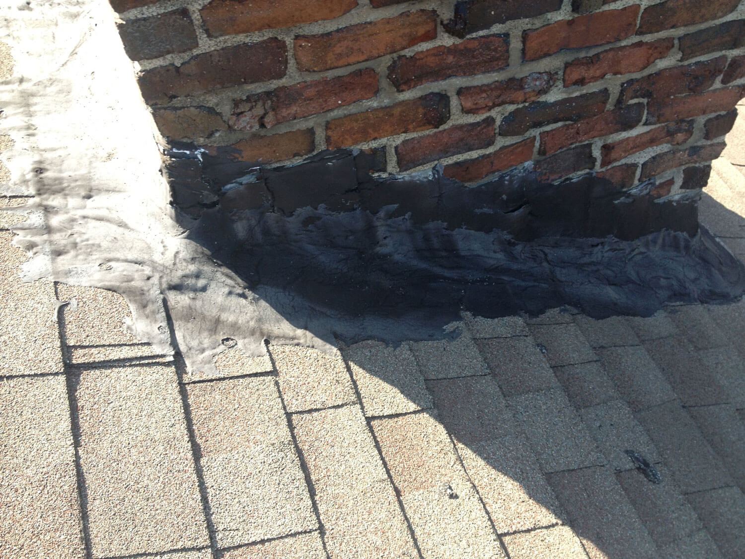 Chimney base flashing with sealant