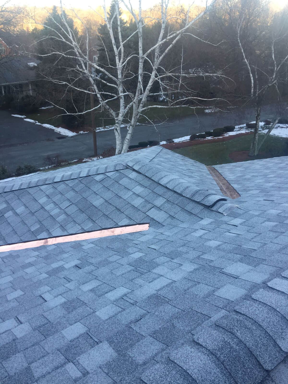 New asphalt shingle roof with copper ridge cap